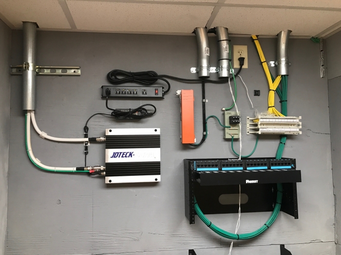 Consumer grade quad band repeater installed in comm room. JDTECK  ensures that all approved techs maintain the highest quality standards when completing a system deployment. 