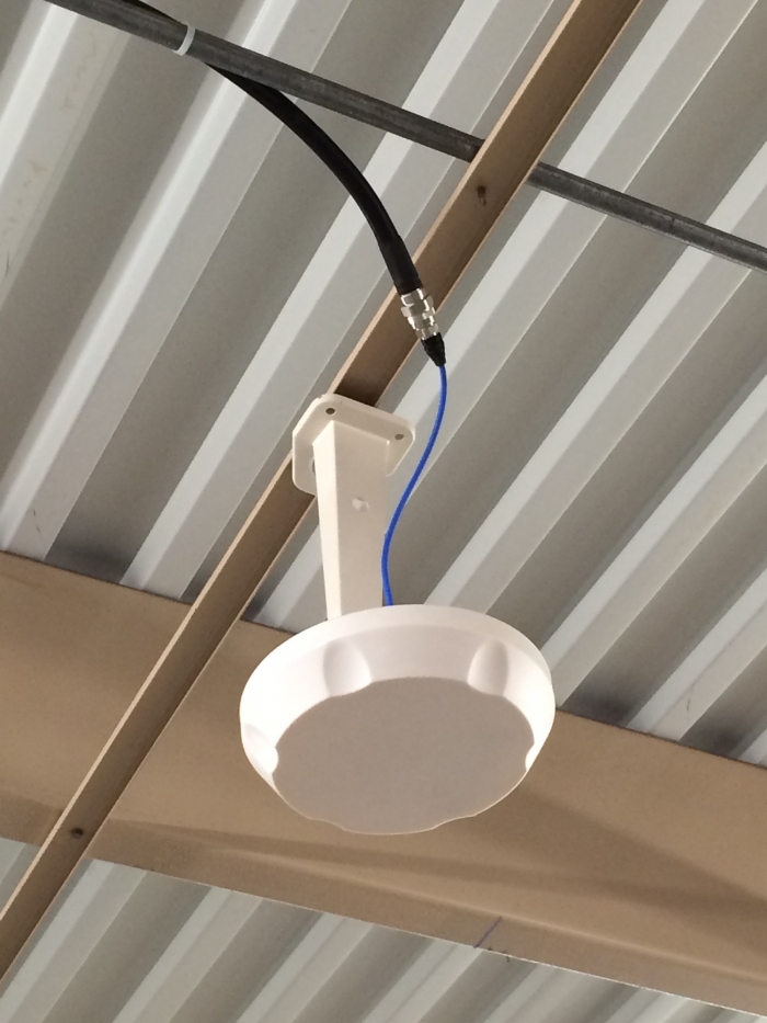 Dome antenna installed in warehouse with bracket. 
