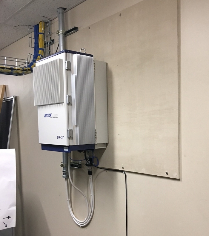 Quad Band Digital Repeater installed in communications room of customer's site. IP66 rated enclosure with built-In cooling fans.  