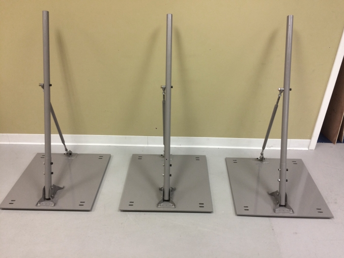 Custom designed and fabricated antenna brackets for deployment on pitched / ribbed metal roof at government facility. Base plates made from 3/8